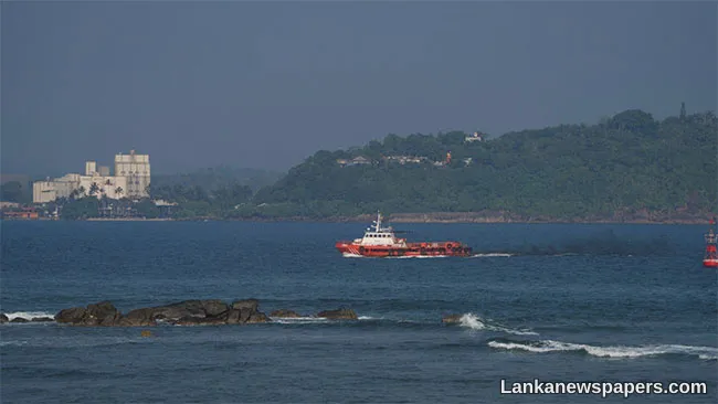 Coast Guard personnel clean up oil spillage in seas off Hikkaduwa